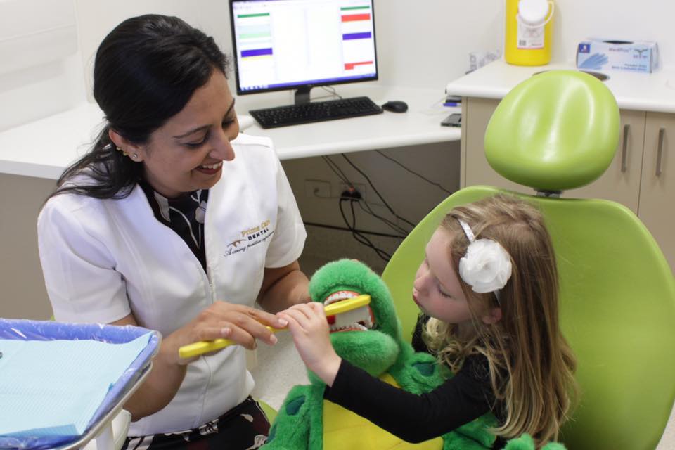 dr puja chowdhry with kid patient dentist wodonga