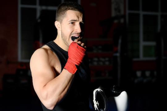 Boxing fighter putting on mouthguard. what type of mouthguard offers the best protection wodonga